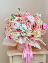 Pink cloud - flower box arrangement with peonies, spray roses, pink roses, stock flowers and hydrangeas.