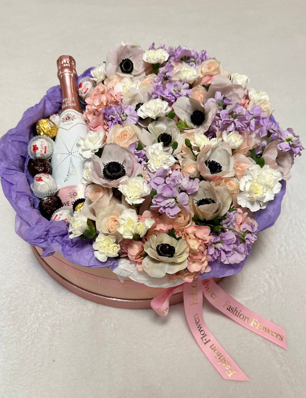 «Floral champagne» - box with sparkling wine, sweets and assorted flowers.
